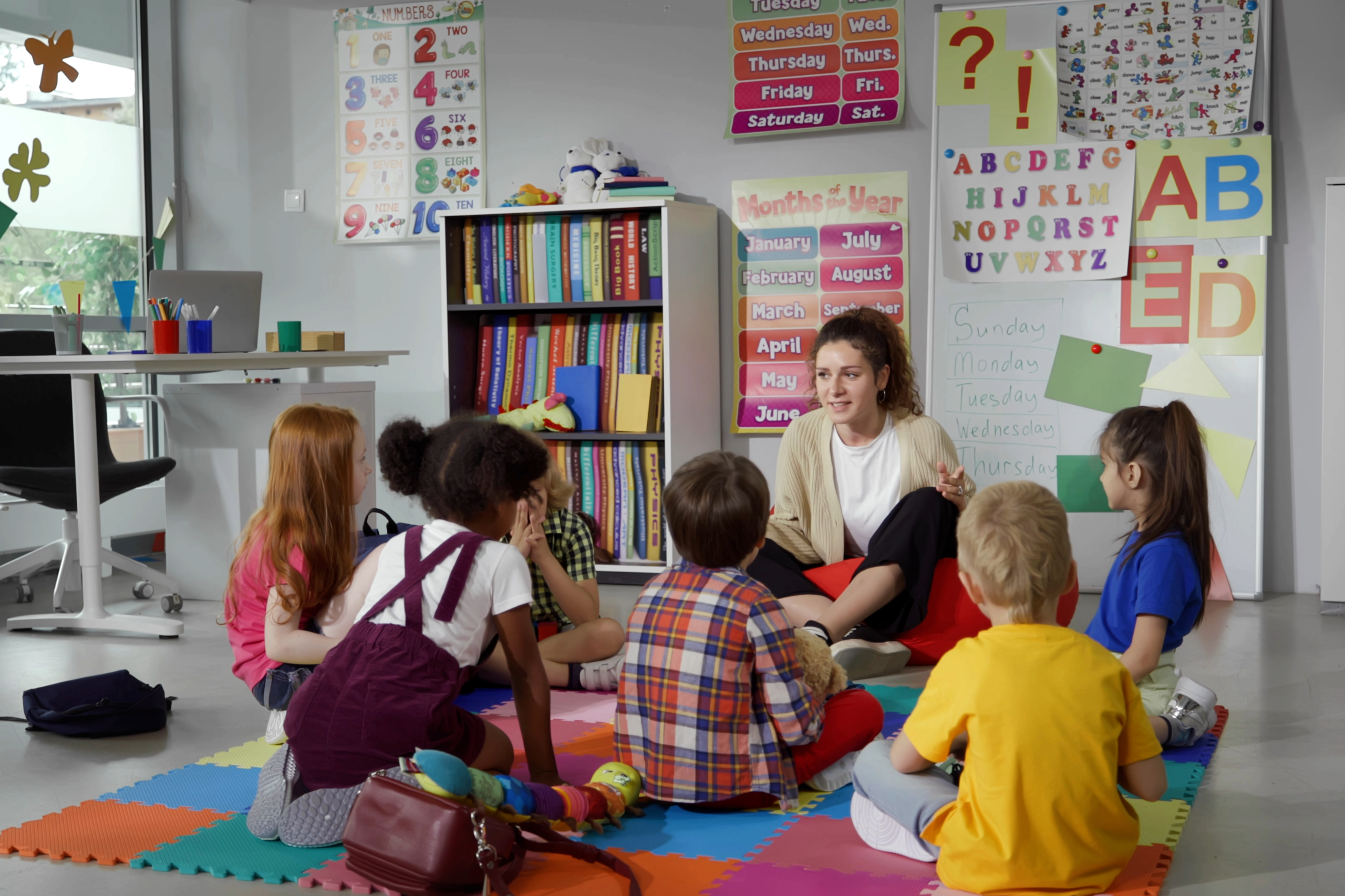 Pre-School teacher teaching children